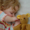 Baby with bear lovey