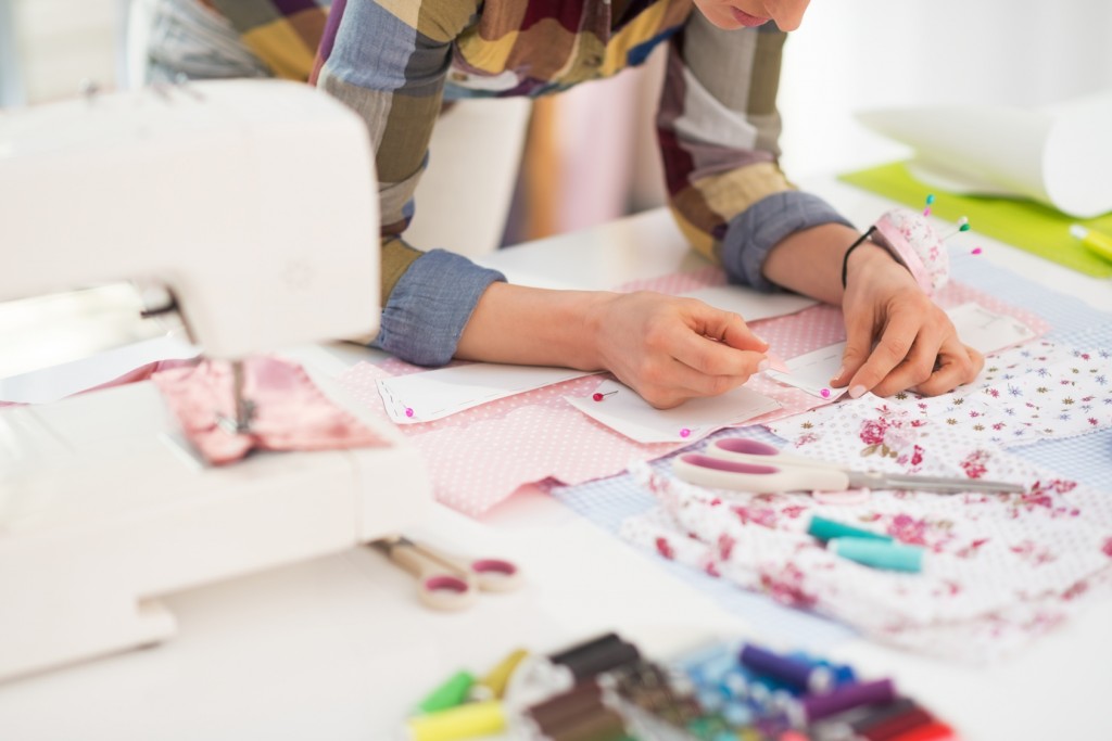 Closeup on seamstress working in studio