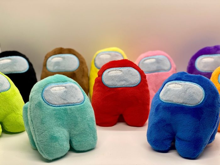 Colorful alien-robot plushies in a semi circle