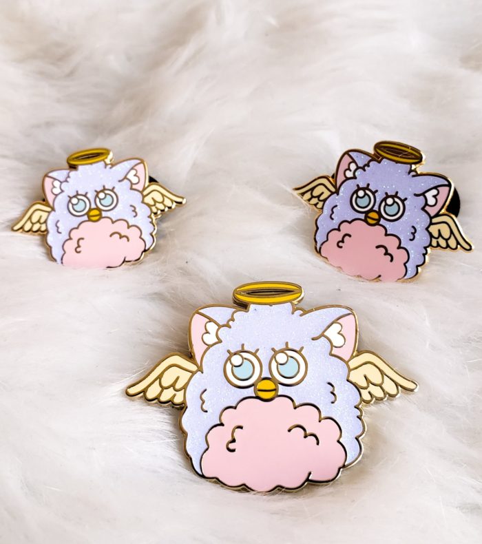 Furby enaml pin with an angel halo and cute eyes