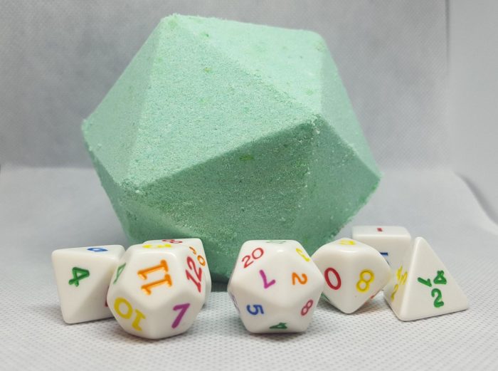 A large 10 sided dice made of soap in light green with a set of colorful dice around it