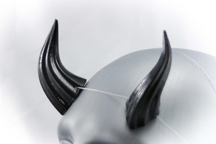 black, shiny, horns on a light grey model head